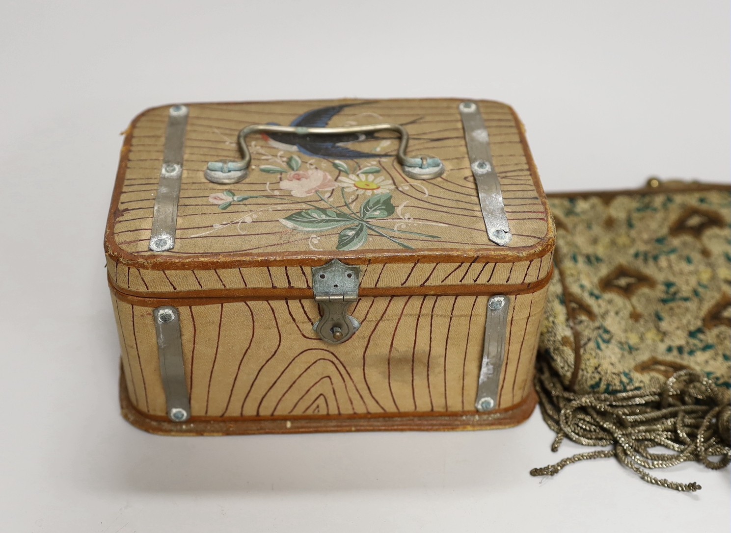 A suitcase containing a collection of late 19th century leather sewing bags and containers, wooden darning mushrooms, etc